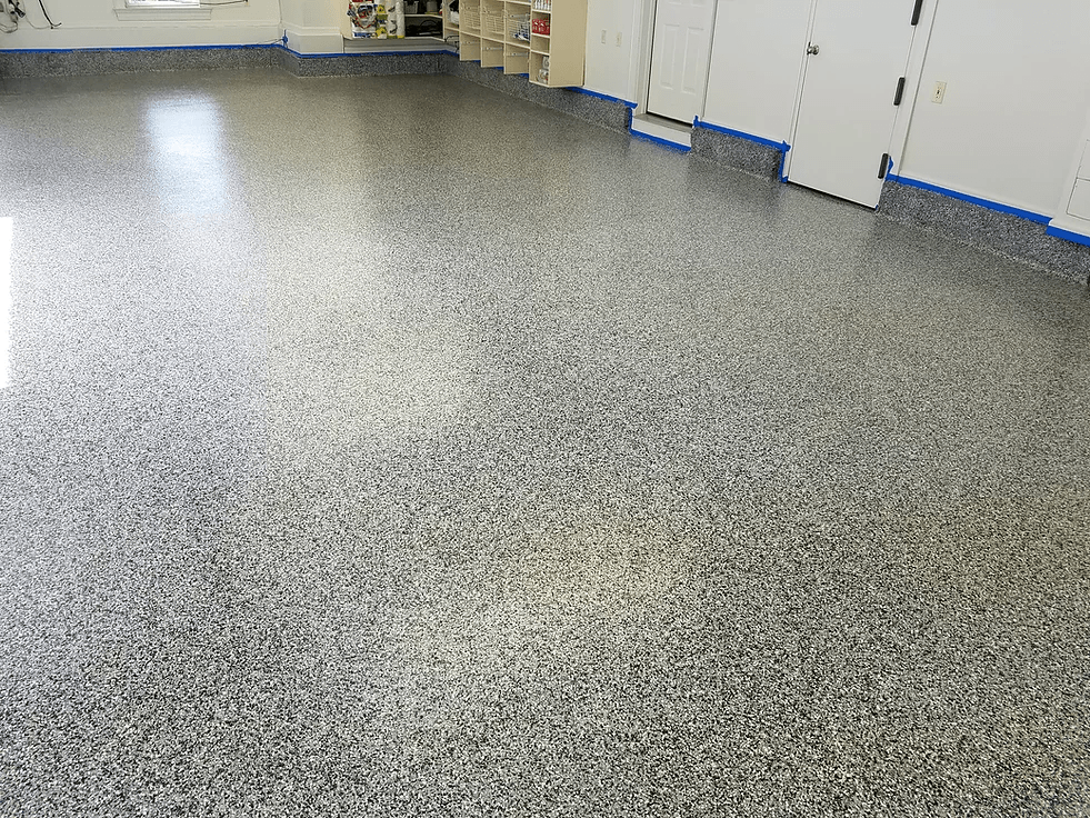 a garage with a gray floor and white walls .