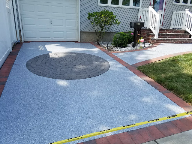 a driveway with a circular design in the middle of it