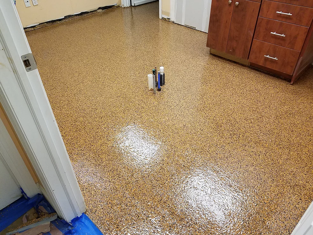 a room with a shiny floor and a door .
