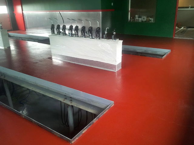 a room with a red floor and a white box on it