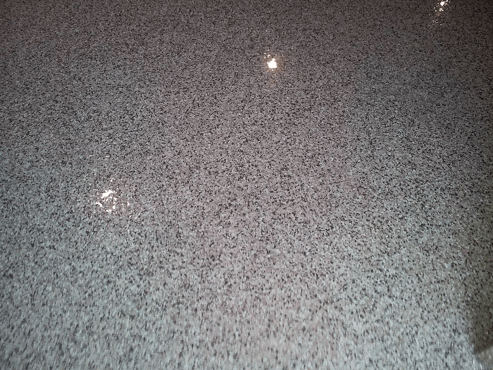 a close up of a white tile floor with a lot of small stones on it .