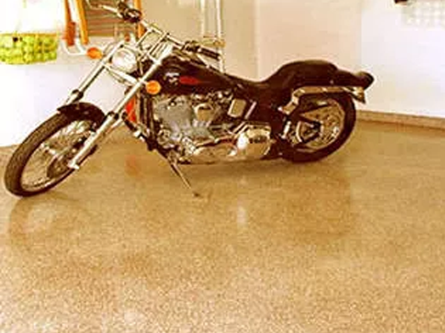 a harley davidson motorcycle is parked in a garage .