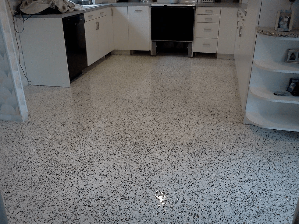 a kitchen with white cabinets and a white floor