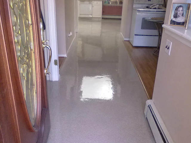 a hallway with a picture of a woman on the wall