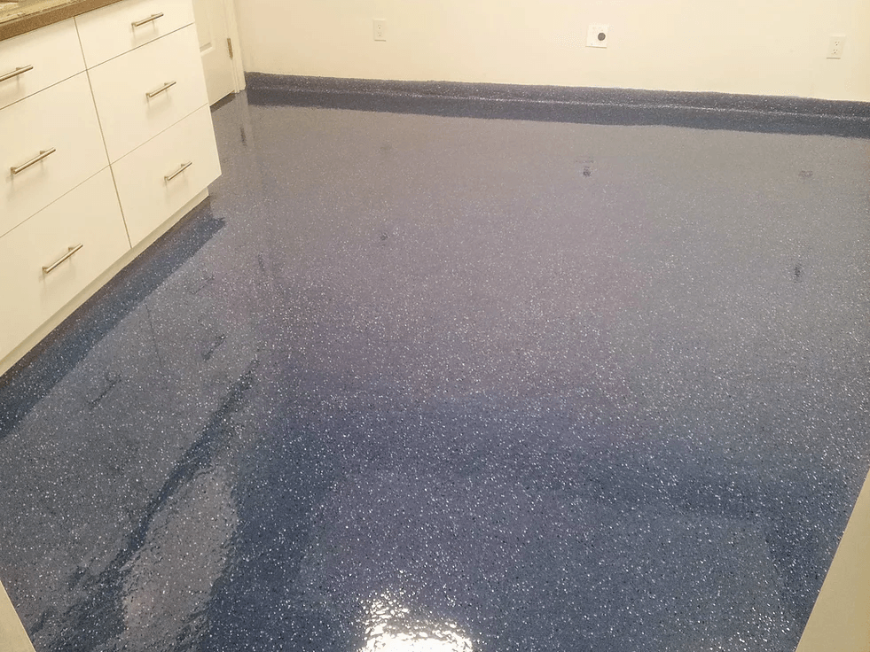 a kitchen with a blue floor and white cabinets
