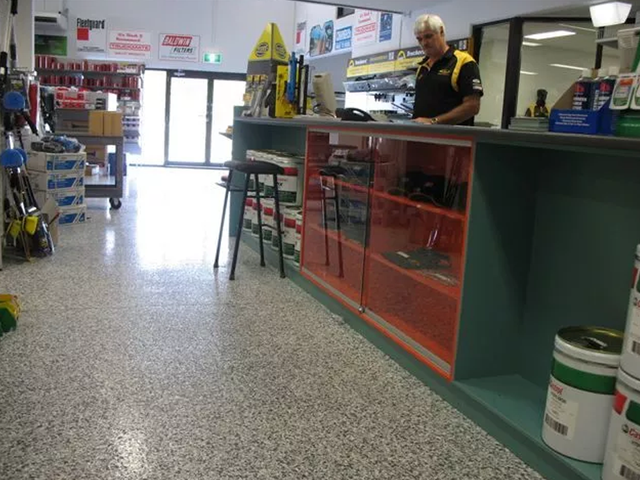 a man stands behind a counter in a store