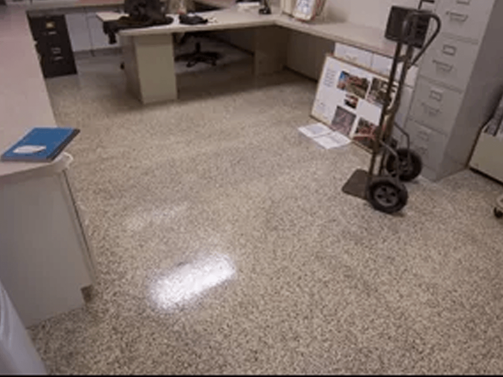 a room with a cart on the floor and a desk