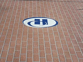 a brick floor with a blue and white logo on it