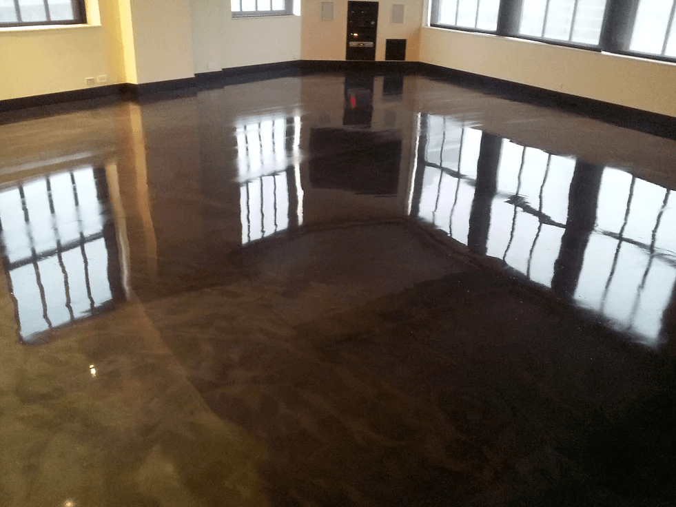 a room with a shiny floor and a lot of windows