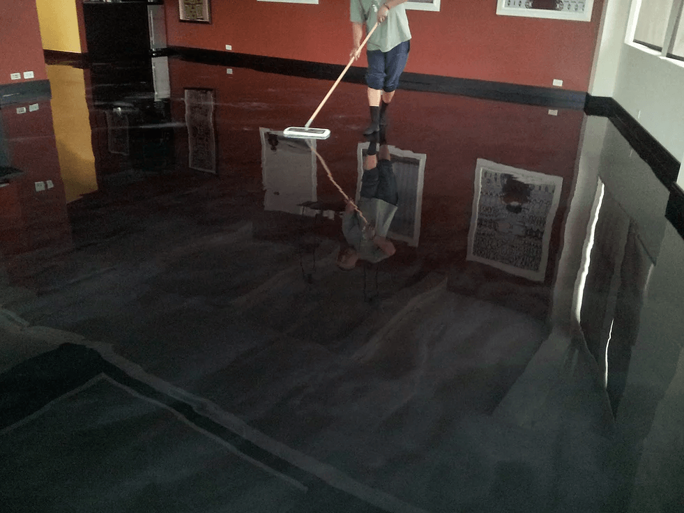 a man is mopping the floor in a dark room