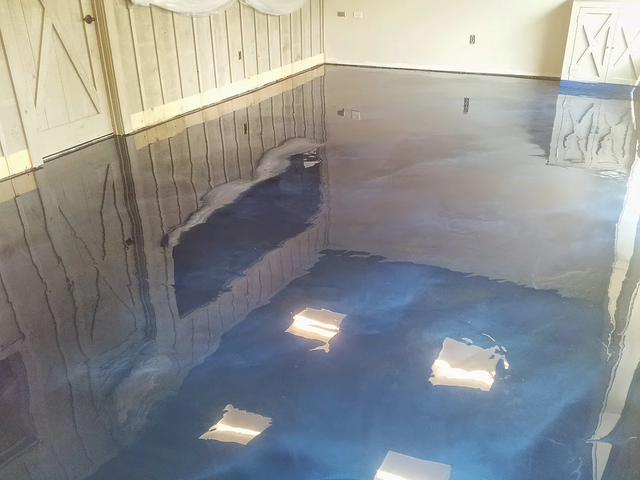 a room with a blue floor and a wooden wall .