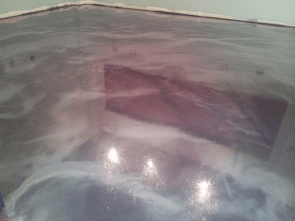 a purple floor with a reflection of a building in it .