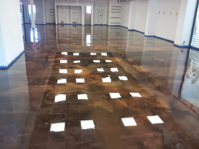 a large room with a shiny floor and squares on it