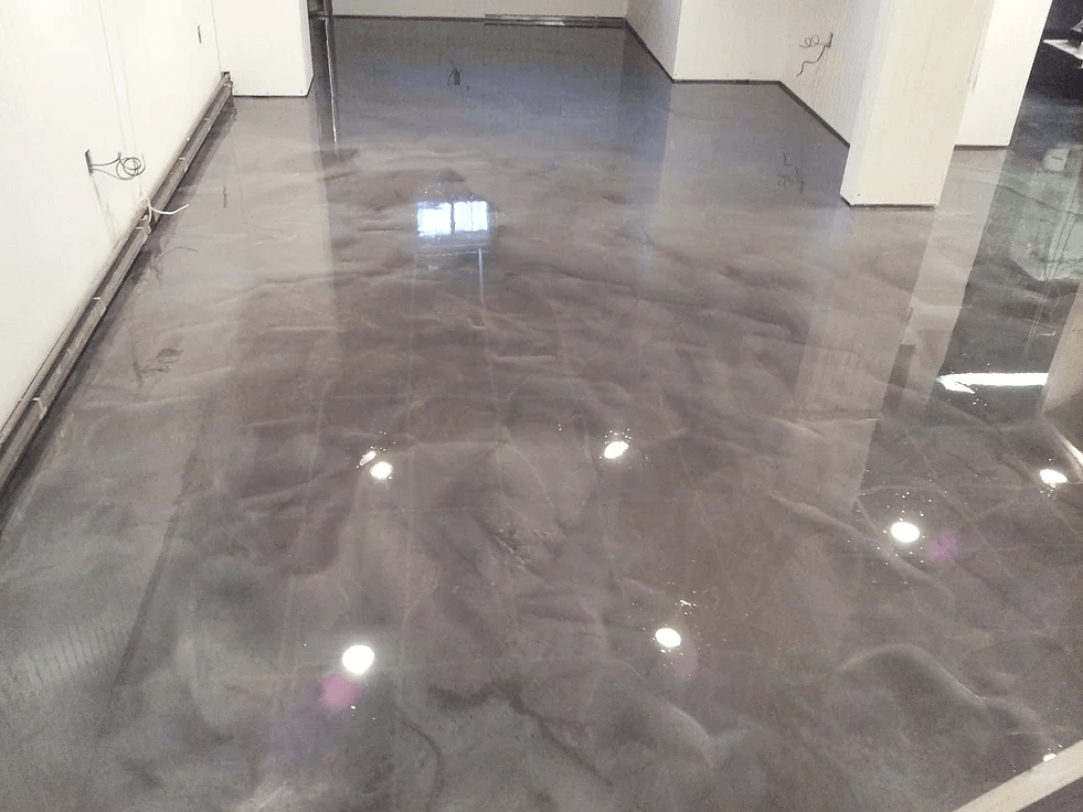 a shiny metallic floor in a room with white walls .
