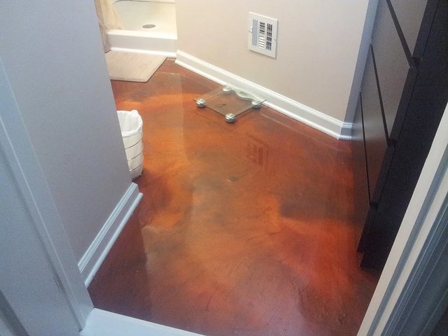 a bathroom with a scale on the floor