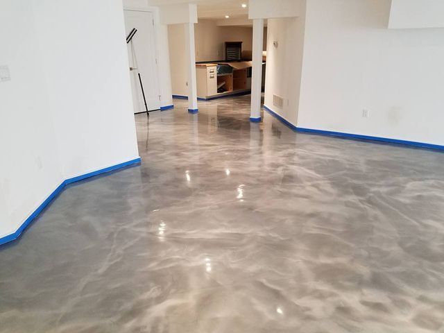 a room with a metallic floor and white walls