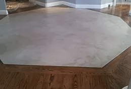 a white tile floor with a wooden floor in a living room .