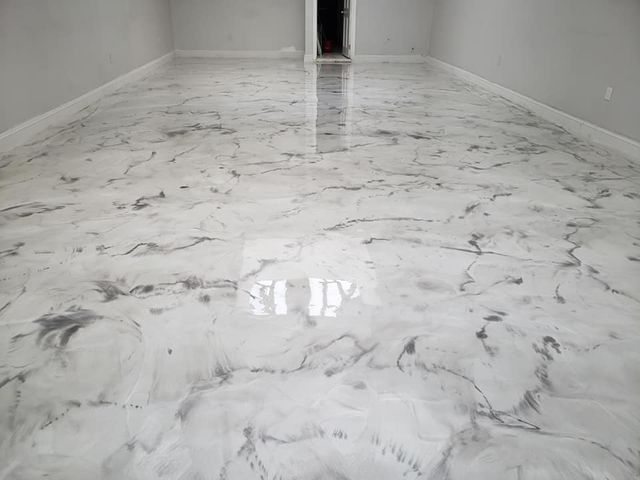 a room with a white marble floor and white walls .