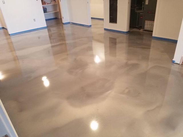a living room with a shiny metallic floor and white walls .