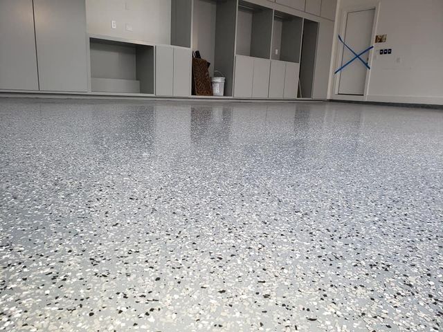 a garage floor with a lot of small stones on it