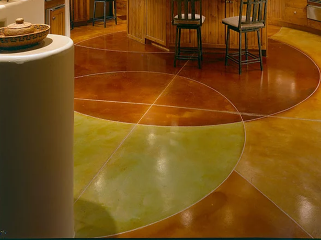 a kitchen with a circular pattern on the floor