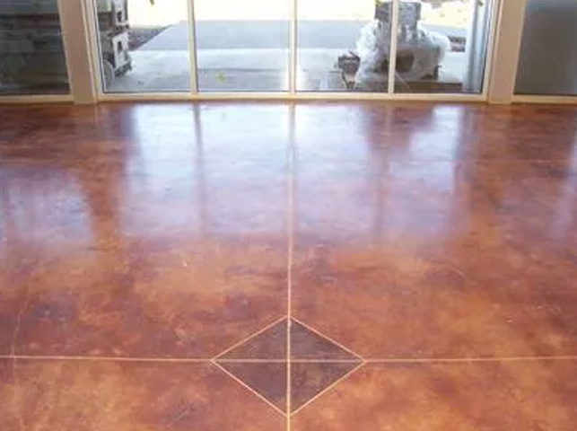 a concrete floor with a diamond pattern and a sliding glass door .