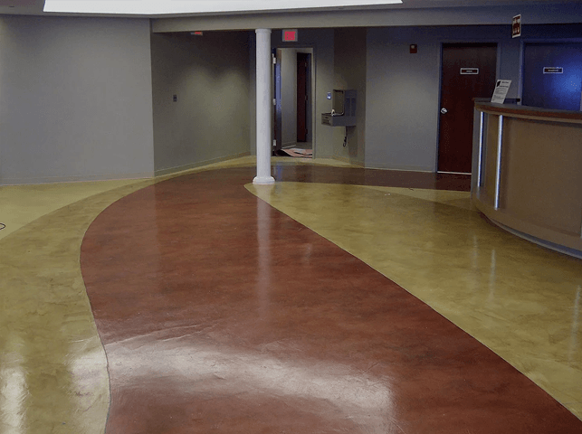 a lobby with a red and tan floor and a counter