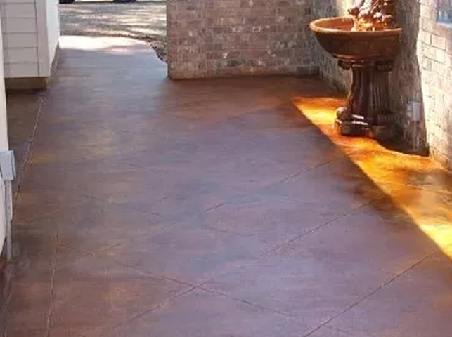 a concrete floor with a fountain in the background .