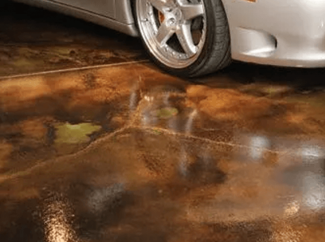 a car is parked on a concrete floor in a garage .