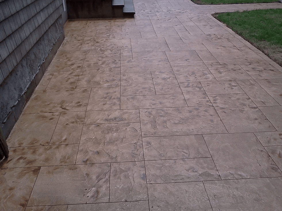a brick walkway with a staircase in the background