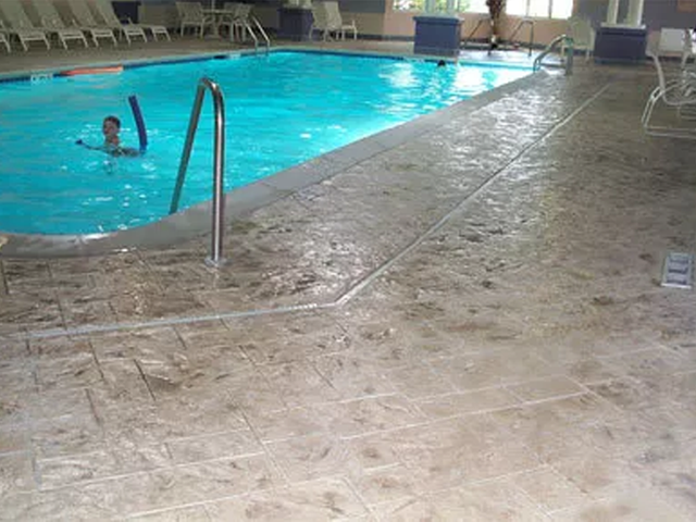 a man is swimming in an indoor swimming pool