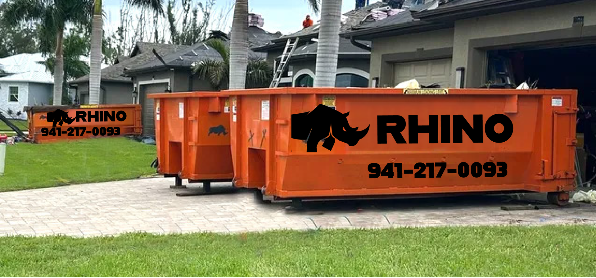 2 orange dumpsters from Rhino are parked in North Port Florida.