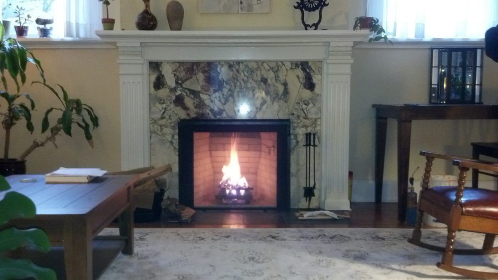 A living room with a fireplace and a rocking chair