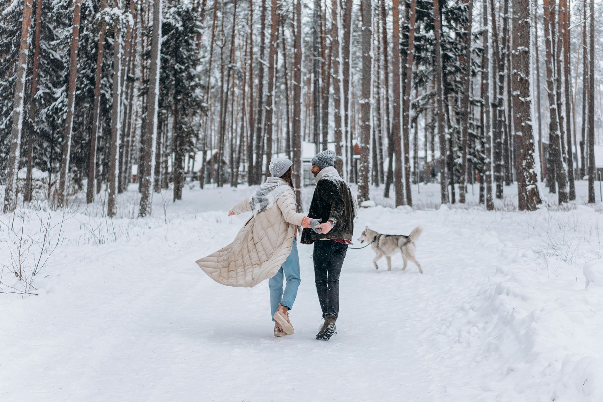 a couple in the woods with their dog