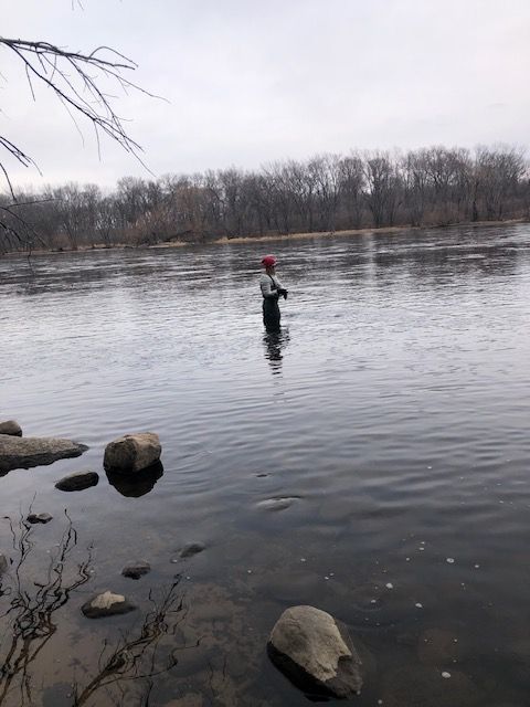 A fisherman in a large river