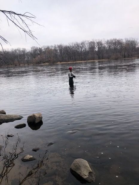 A fisherman in a large river