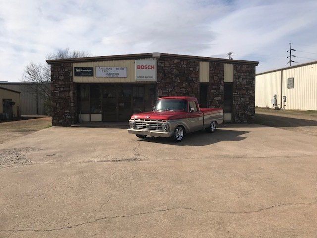 Red Truck is Parked in Front of the Shop