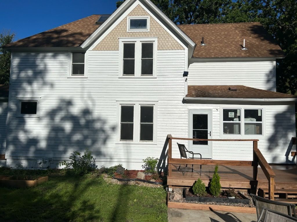 A large house with a chimney on the side of it