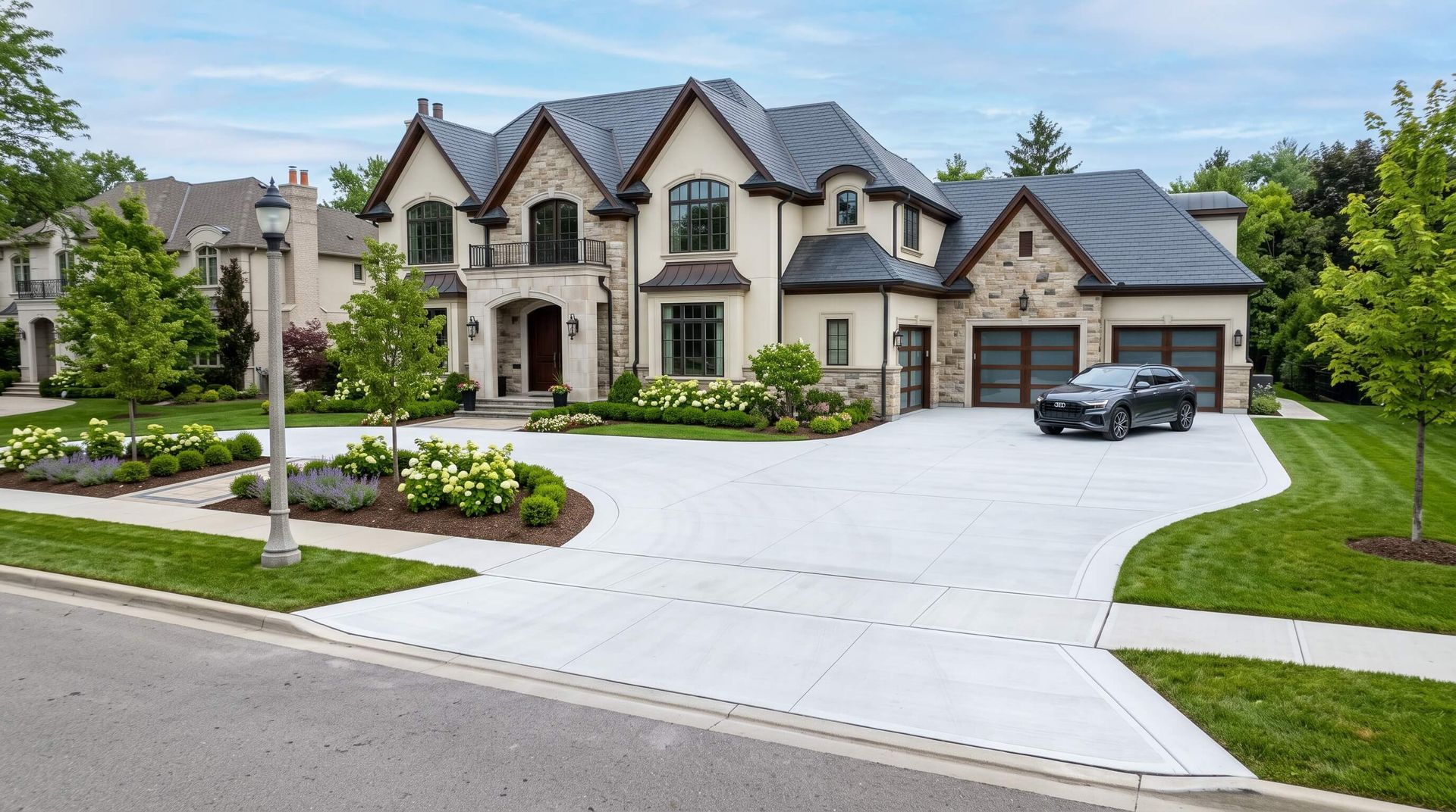 A luxurious house that has just had a new concrete driveway installed.