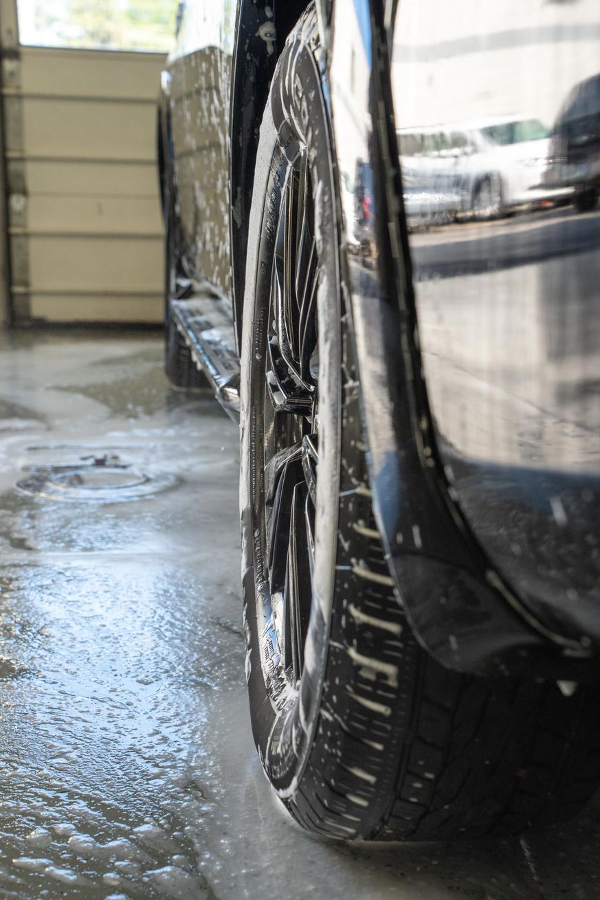 A close up of a car 's tire in a garage