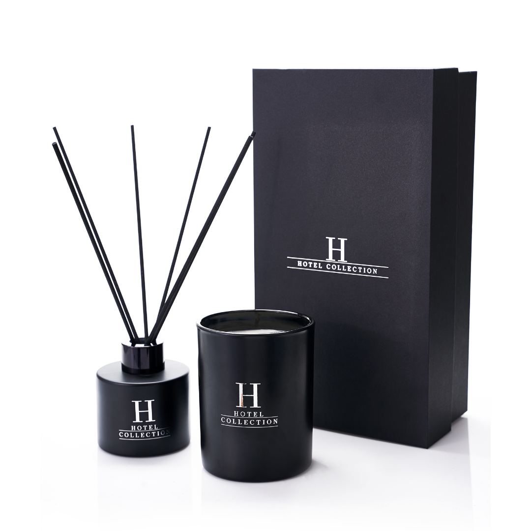 Two black candles and a black box with the letter h on it