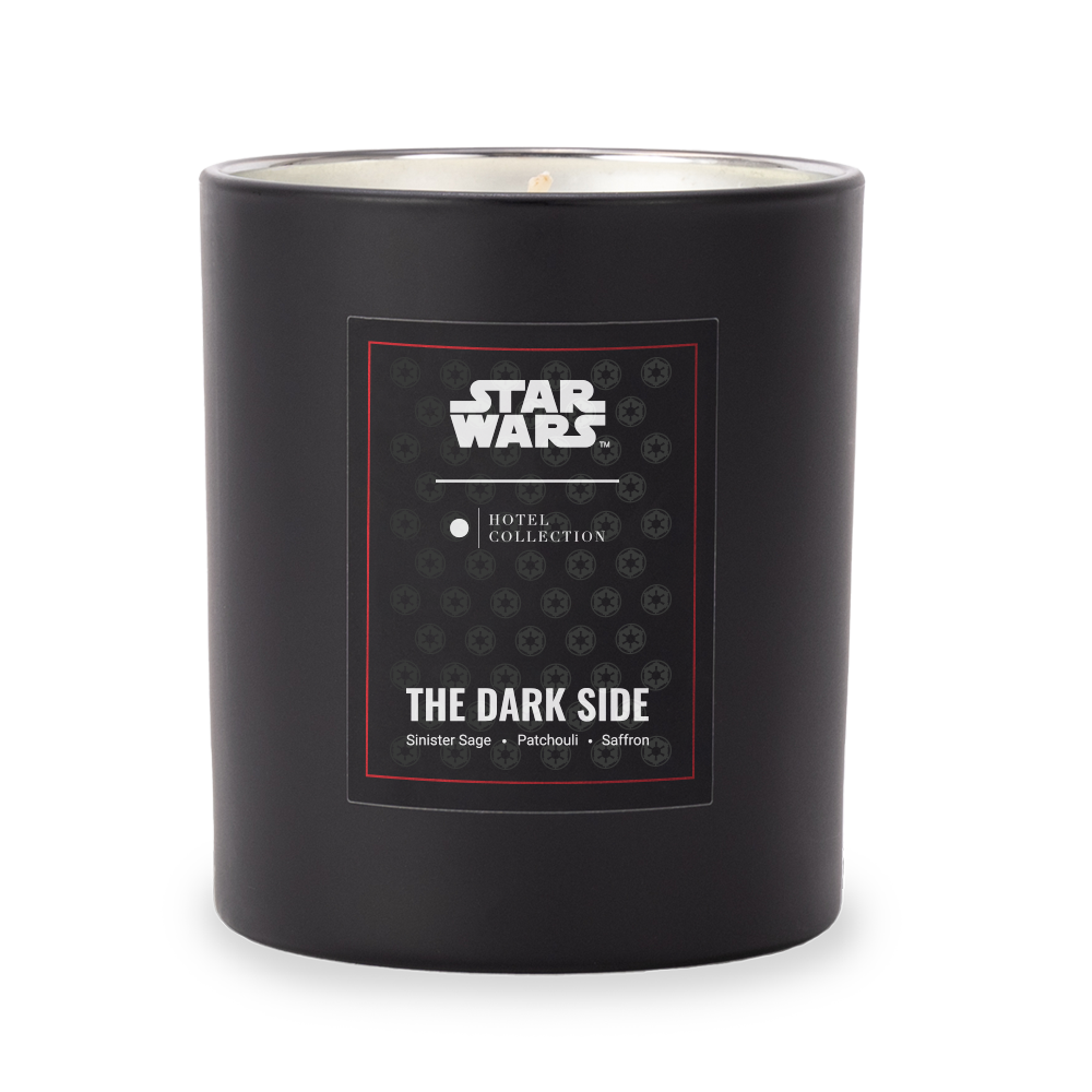 A black star wars candle with a label that says the dark side