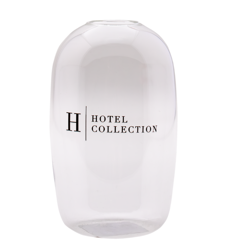 A clear glass vase that says hotel collection on it