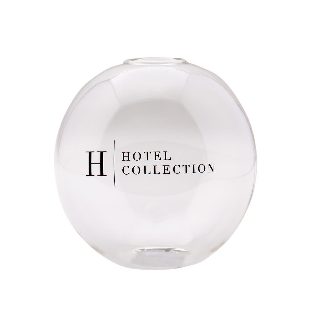 A clear glass ball with the word hotel collection on it