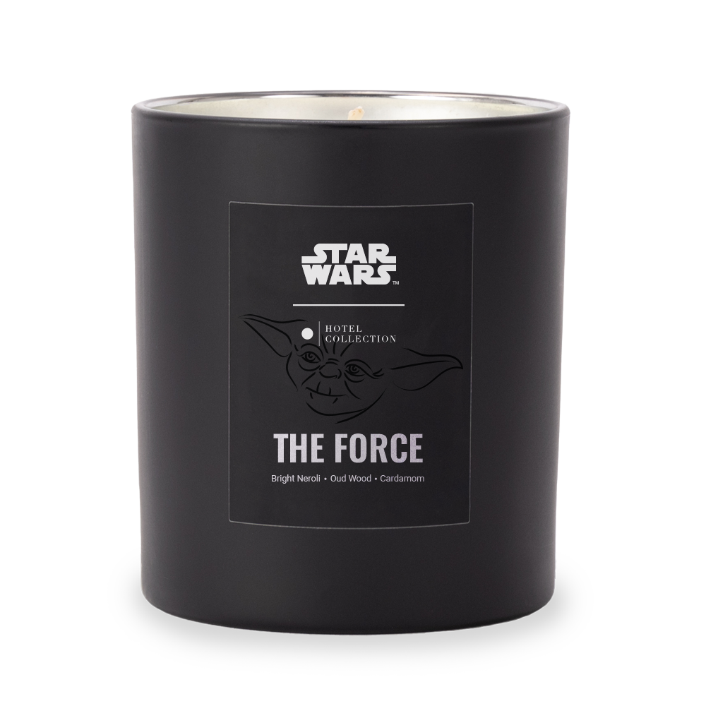 A black star wars candle with a picture of yoda on it.