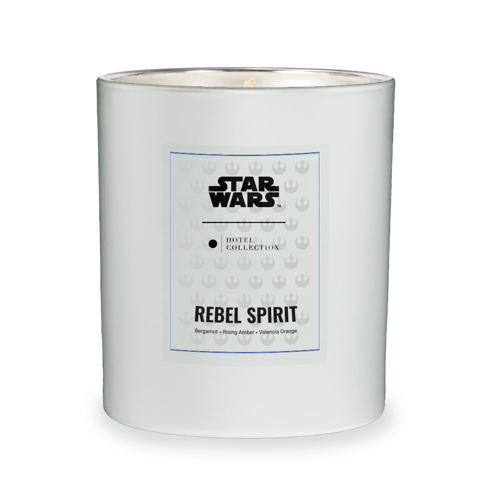 A white candle with a label that says rebel spirit on it.