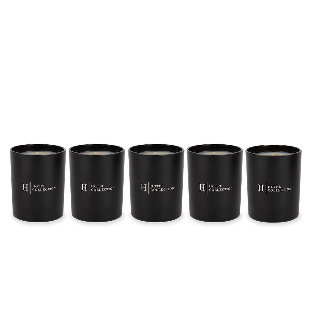 Five black candles are lined up in a row on a white background.