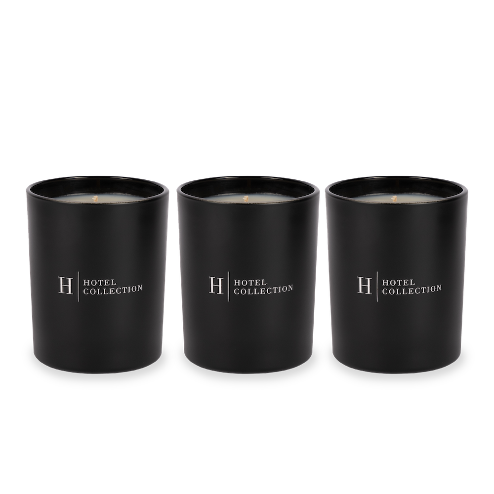 Three black candles are sitting next to each other on a white background.