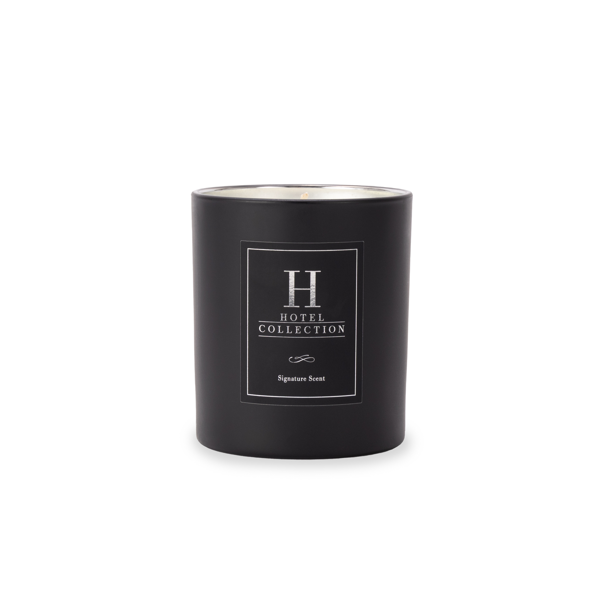 A black candle with a white label on it is on a white background.