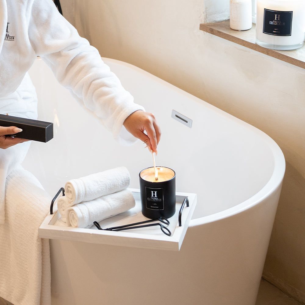 A person is pouring a candle into a bathtub.